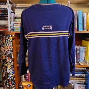 Vintage blue t-shirt with stripes and embroidered detail.